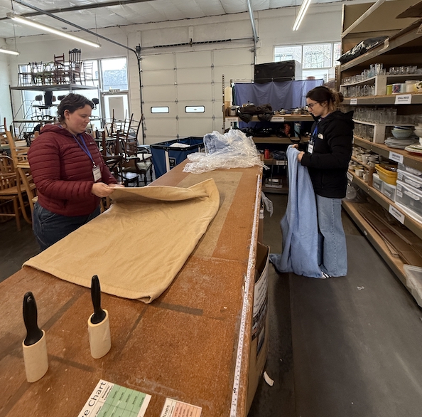 Two PSU students sort linens at Community Warehouse