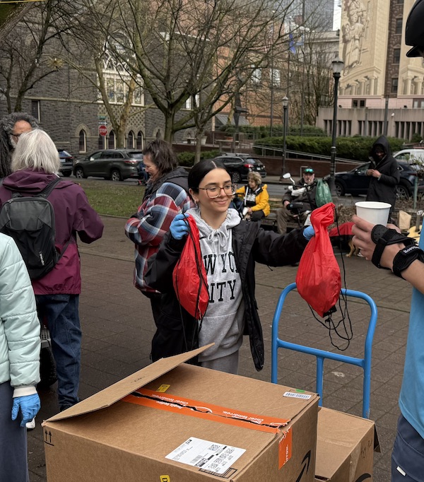 Ghazal Alzghoul hands out hygiene kits at Clay Street Table