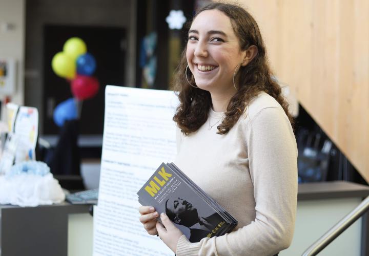 Student handing out MLK Day of Service Flyers