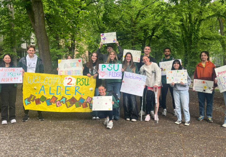 group of students holding welcome alder signs