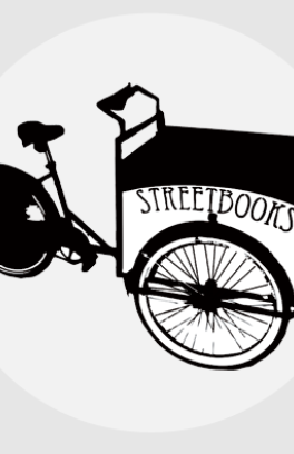 black and white bicycle with cargo box in front that reads Street Books