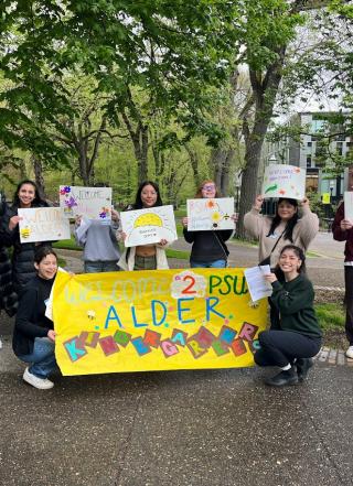 Group of students holding banner saying Alder College Day