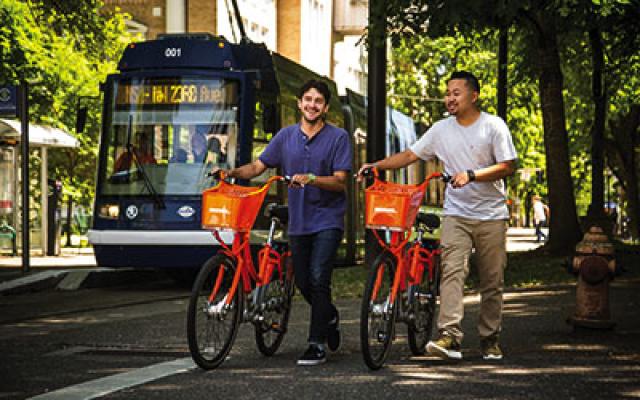 Students walking with Biketown Bikes