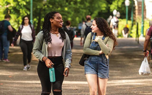 Two students walking along the park blocks