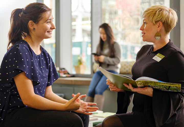 A student organization advisor consulting with a student