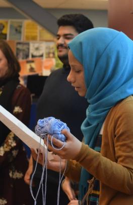 MENASA Group - student speaking holding yarn