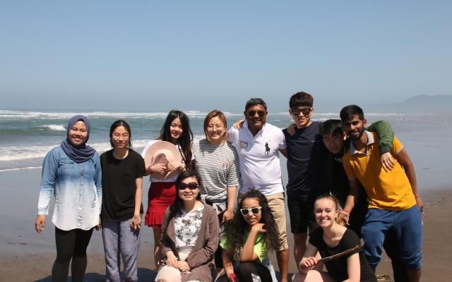 PSU international students standing as a group on the beach.