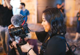 Woman holding video camera.