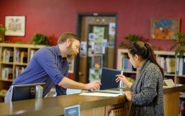 person getting help at a service counter