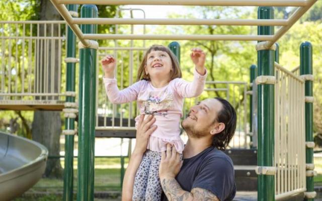 Child and parent playing on a playground