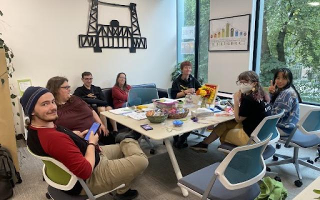 A group of students sitting around a table talking