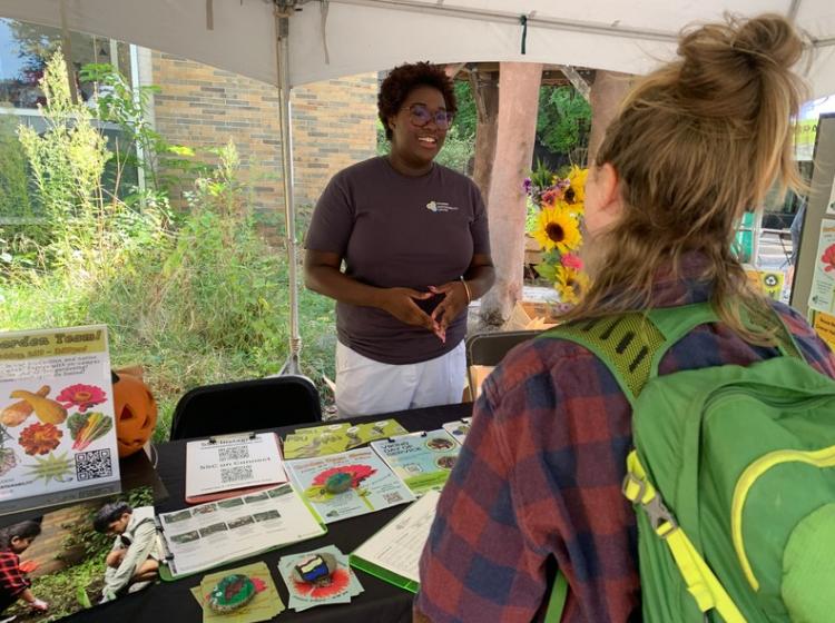 SSC student speaking to another student at an outreach table