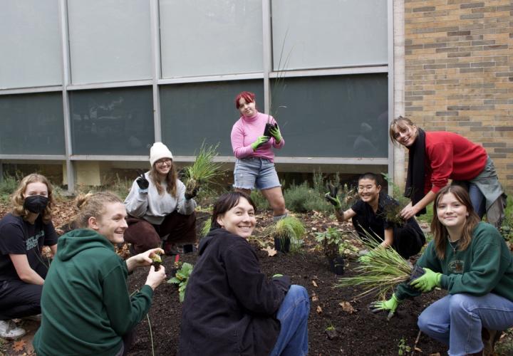 Eight people are shown smiling and gardening.