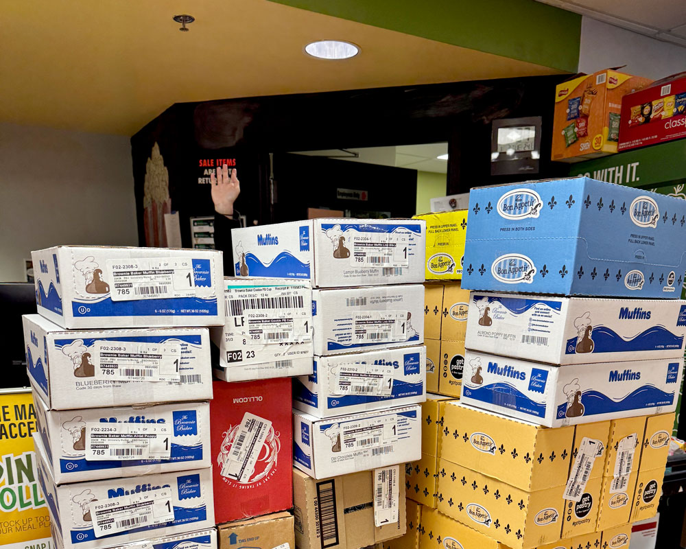 Student's hand in air shows height of delivery order to Market