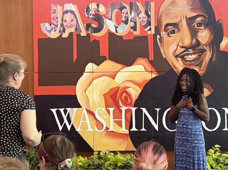Artist Kyra Watkins discusses the Jason Washington Memorial Mural she created during the community event in Smith Memorial Student Union.
