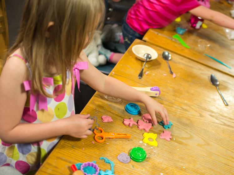 A child playing with Play-Doh.