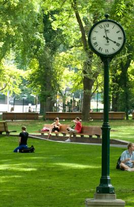The lush park blocks with students in the grass and on benches
