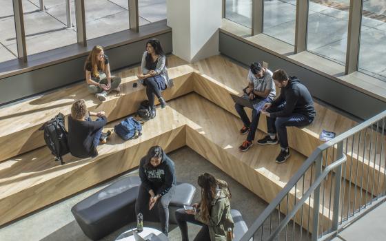 Several people gathered in a study space