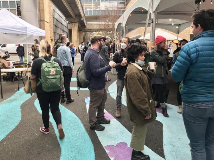 People gathered under a canopy