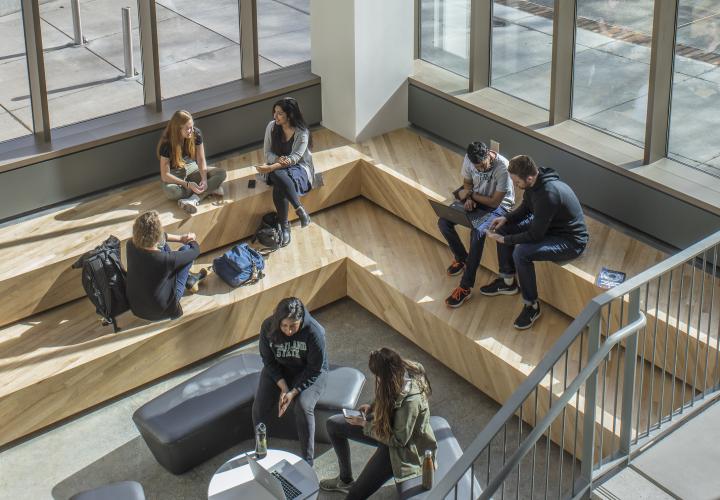 Several people gathered in a study space