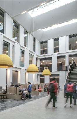 students walking through building atrium