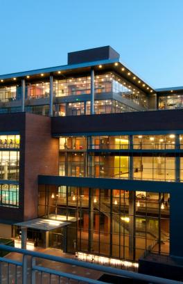 Large building at night illuminated by indoor lights