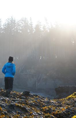 researcher stands in front of water 