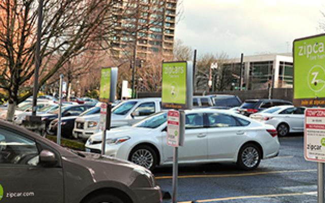 cars parked next to sign that says zipper