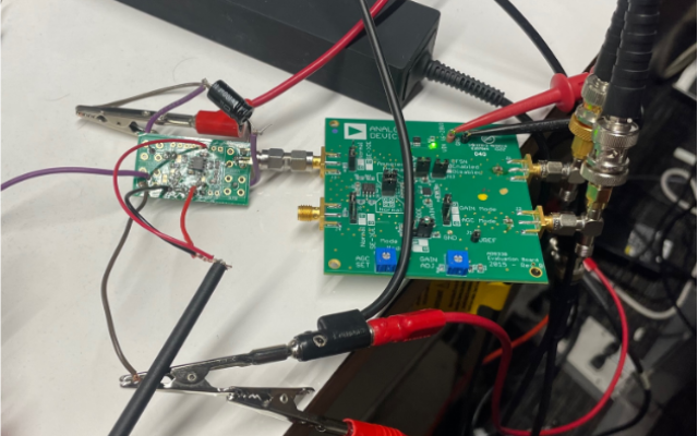 An electronic control board with many black and red wires.