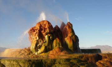 Photo of natural geyser formation spouting water into sky