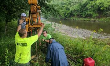 USGS Scientists drilling along a stream