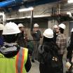 students in hard hats in mechanical room of student rec center