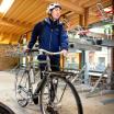 Person rolling bike inside a bike parking structure
