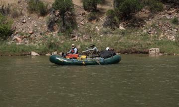 National Park Services employees paddle down the Green River in Dinosaur National Monument
