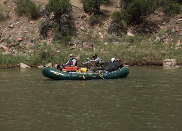 National Park Services employees paddle down the Green River in Dinosaur National Monument