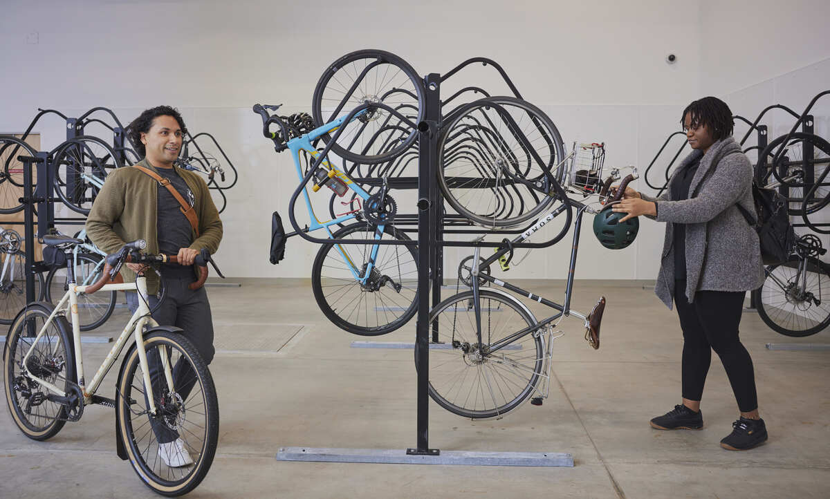 Two students looking at bikes on a rack