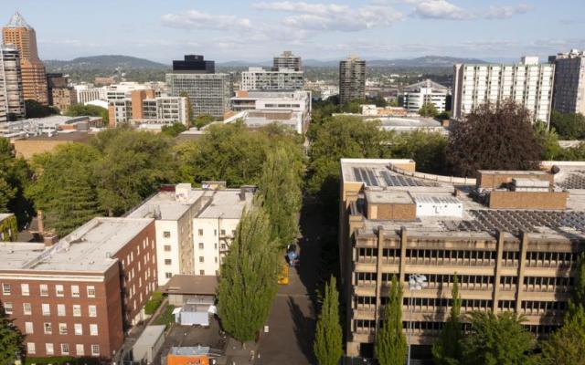 Aerial view of the Portland State University campus and surrounding downtown city buildings under a blue sky