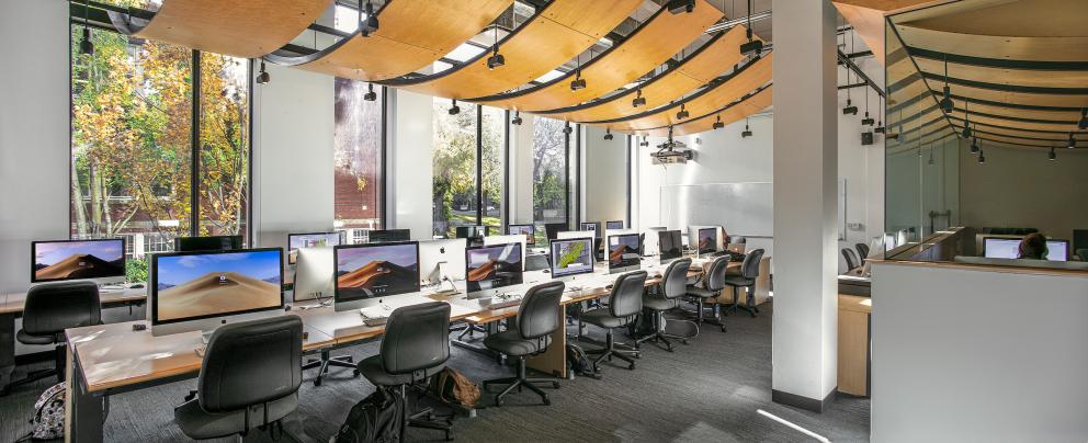 Computer lab at Portland State University with a long table of iMacs