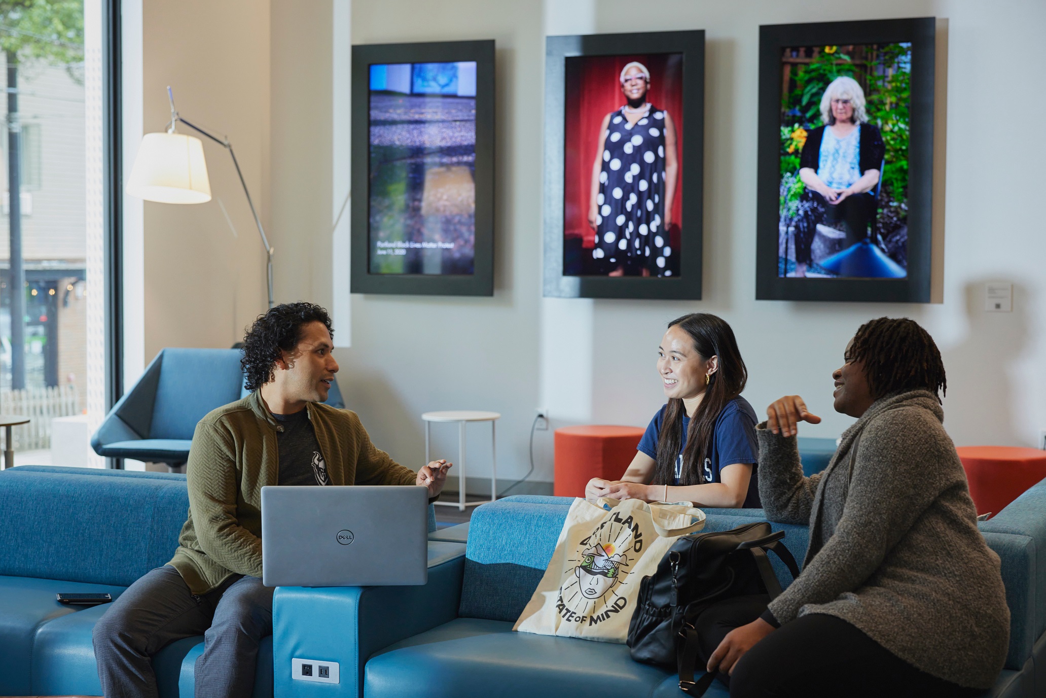three individuals collaborating in a common space