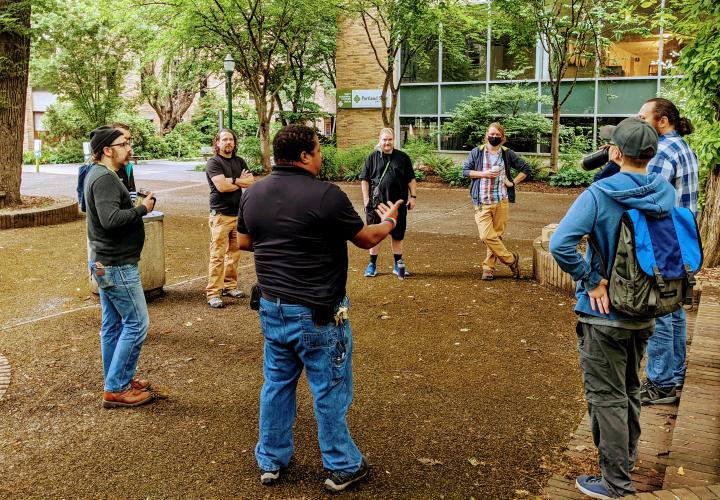 Group of OIT employees discussing in the PSU park blocks