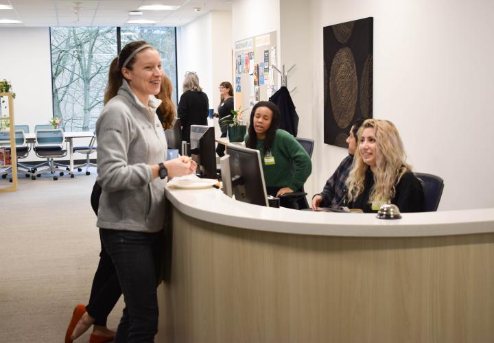 student employees at the TRSRC front desk greet a visitor