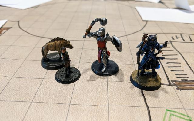 Four miniature figurines used for playing dungeons and dragons