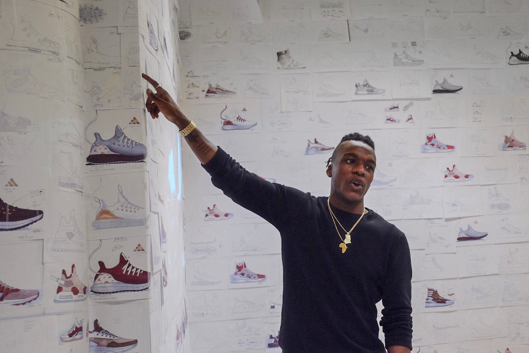 student pointing to a wall of advertising