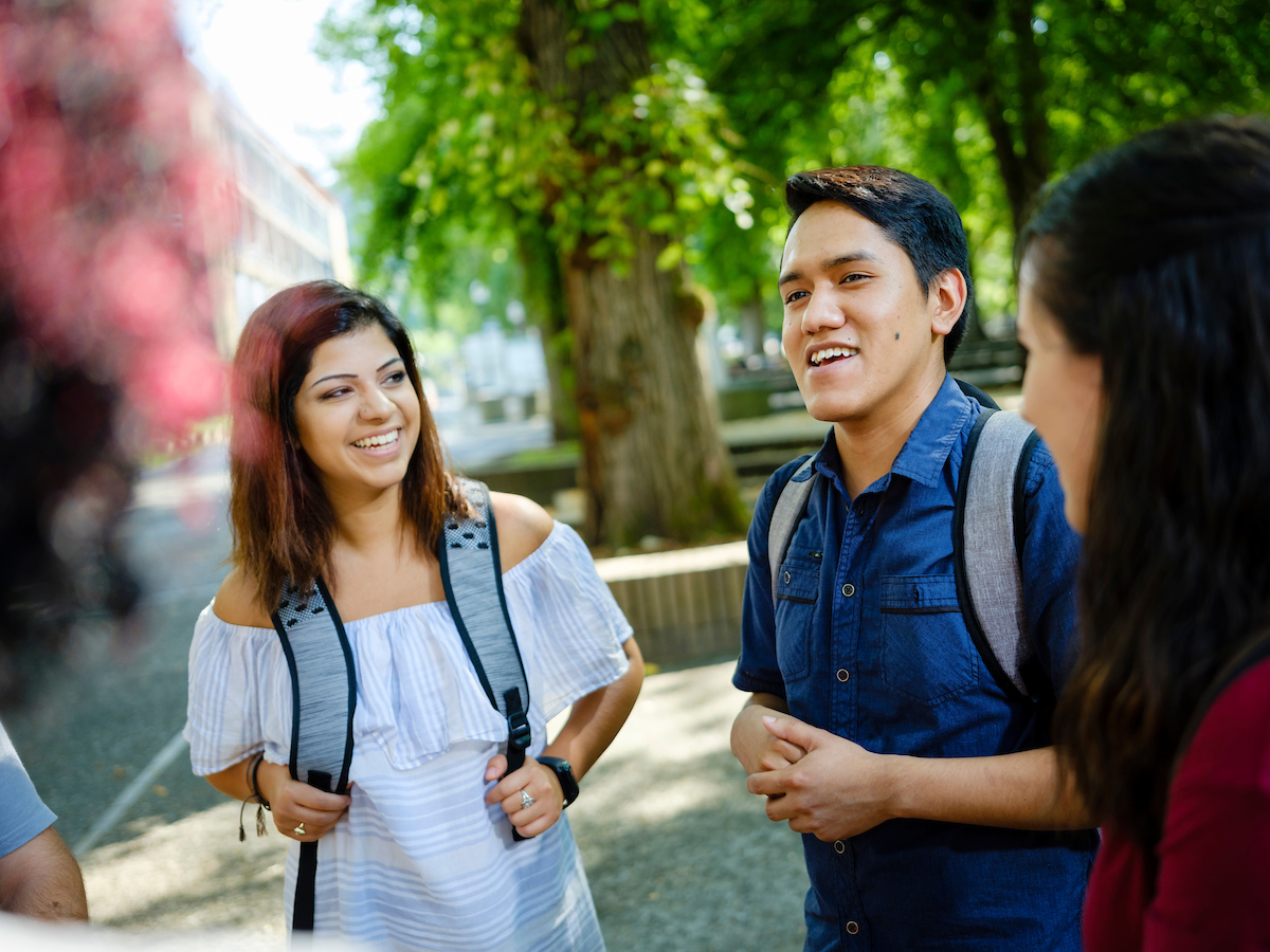 Image of two students smiling outside.