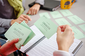 Overhead view of student and advisor engaged in a card-sorting activity