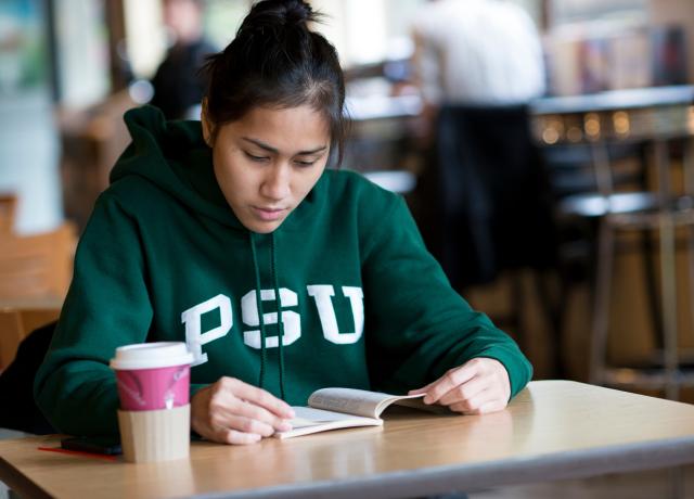 girl in PSU sweatshirt reading