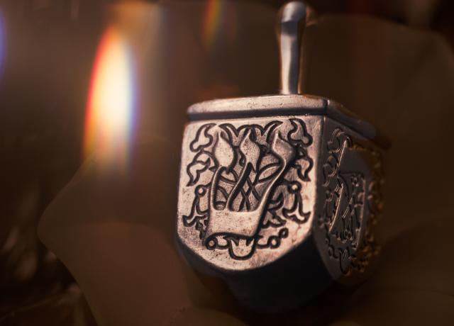 a silver carved dreidel