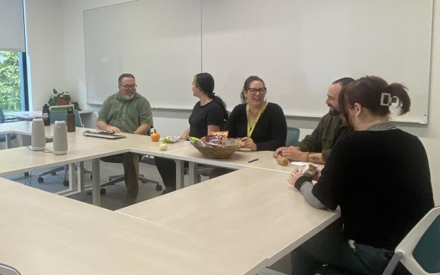 Image of staff and students at table.