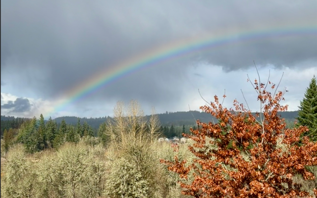 countryside landscape near PCC Rock Creek with a rainbow stretching across the sky