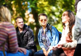 group of students hanging out in the park blocks